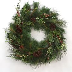 a christmas wreath with pine cones and evergreen needles on white background, ready to be hung