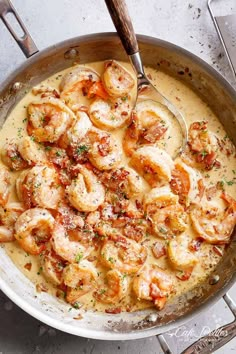 a skillet filled with shrimp and sauce