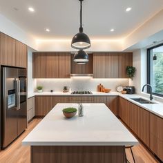 a modern kitchen with wooden cabinets and white counter tops, along with stainless steel appliances