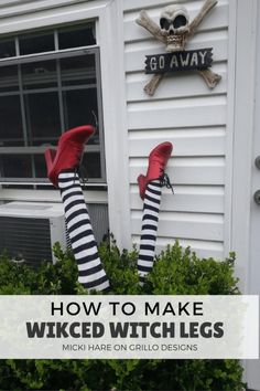 someone wearing striped socks and red shoes standing in front of a house with their feet up