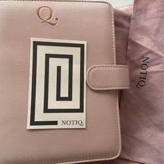 a pink purse with a sticker on it