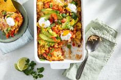 a casserole dish with chicken, avocado and sour cream