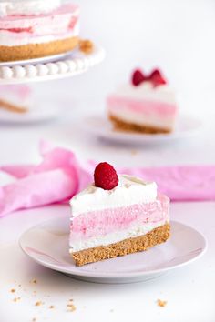 a piece of cake on a plate with raspberries and cream cheesecake in the background