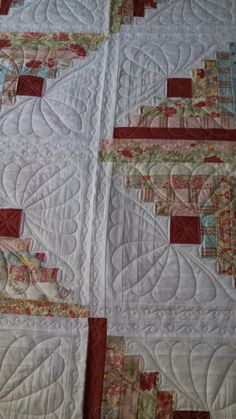 a close up of a quilt on a bed