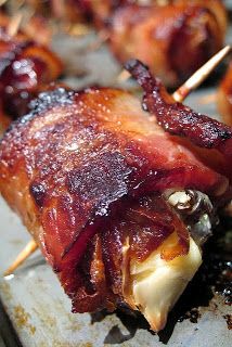 bacon wrapped in toothpicks on a plate with other food items around it,