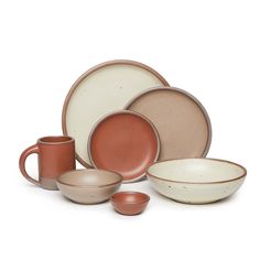 an assortment of dishes and cups with brown rims on the top, in different colors