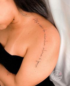 the back of a woman's shoulder with writing on her left arm and chest