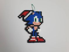 an ornament made to look like sonic the hedgehog is hanging on a wall