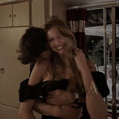 two women hugging each other in the kitchen