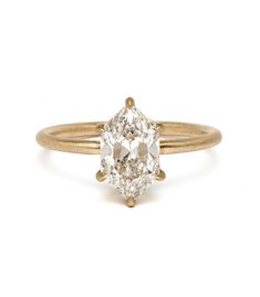 an old mine cut diamond ring, set in yellow gold and setting on a white background