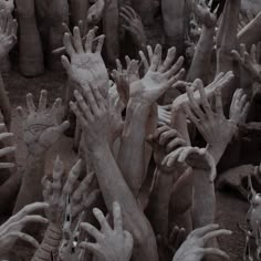 many hands reaching up in the air to reach something out of the ground with their fingers