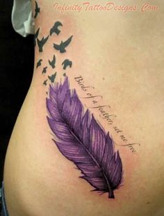 a woman's back with a purple feather and birds flying around her tattoo design