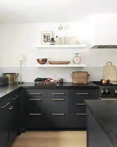 an instagram page with black cabinets and gold accents on the counter top, along with text that reads instagram