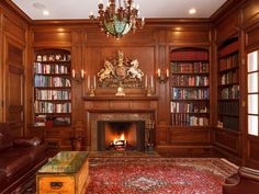 a living room filled with furniture and a fire place under a chandelier in front of a fireplace