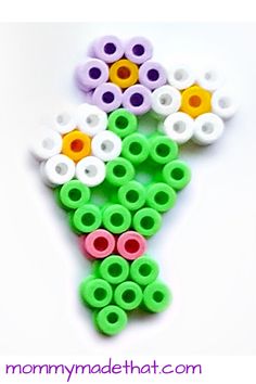 a bunch of flowers made out of plastic beads on a white background with the words mommy made that com