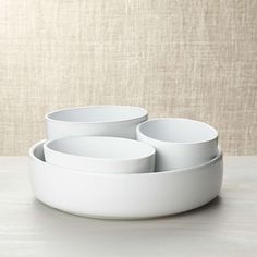 three white bowls sitting on top of each other