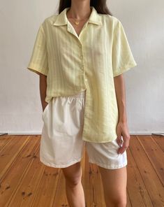 Vintage 90s minimal yellow resort shirt. Features an open revere collar, short sleeves and a subtle textured self stripe. In a soft yellow lightweight fabric.  Brand: CityLife Size label reads EU 42. 100% Polyester.  Based on measurements recommended size UK  8-12 // EU 36-40 // US 4-8  Model is UK size 6/8 and 5'4 and it has an oversized fit.  Length at front: 66cm Bust width (flat): 54cm Sleeve length: 25cm Great condition. Expected signs of wear considering age but nothing notable.  Sourced i Yellow Shirt Outfit, Striped Outfit, Collard Shirt, Resort Shirt, Half Shirts, Revere Collar, Vintage Blouse