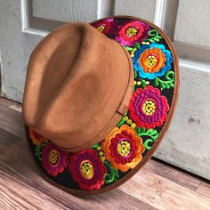 Stand out with this beautiful handcrafted Mexican Suede Hat with beautiful detailed floral embroidered canvas brim. Perfect accessory to add that with that daily outfit. MADE IN MEXICO By: Mexican Artisans For: Women Size: Medium 23' Color: brown | black | multi Details: Top Suede Embroidered canvas brim Inner elastic band Contact us for more details PLEASE READ BEFORE PURCHASE: The picture is an ACCURATE REPRESENTATION.Colors in the pictures may vary a little by effects of light. Each product i Mexican Flower Hat, Mexican Hats For Women, Mexican Inspired Clothing, Hippie Spring Hats With Adjustable Fit, Hippie Spring Hats Adjustable Fit, Hippie Brimmed Hat For Spring, Bohemian Spring Fedora One Size Fits Most, Spring Bohemian Adjustable Fedora, Spring Bohemian Fedora