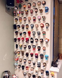 a wall with many head heads on it and a coffee pot next to the window