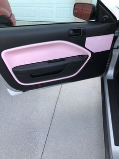 the door handle is pink and black on this car's interior, but it doesn't have any trim to match