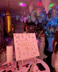 there is a sign that says sweet 16 on it and some balloons in the background