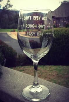 a wine glass that says i don't even ask rough day, easy day