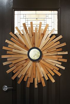 a wooden sunburst hanging on the side of a door