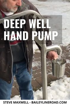 a man holding a metal hand pump with the words deep well hand pump on it