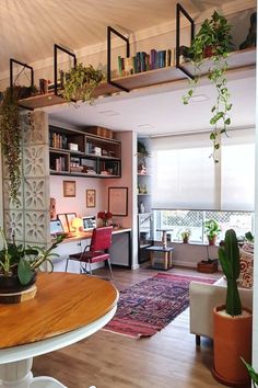 a living room filled with furniture and lots of plants on top of it's shelves