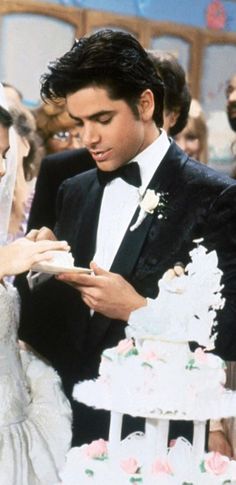 a bride and groom cutting their wedding cake