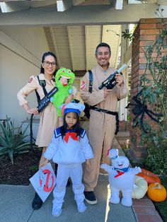 two adults and a child dressed up in costumes