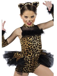 a woman in a leopard print leotard costume with her arms outstretched and hands out