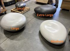 three different types of stools sitting on top of a cement floor next to each other