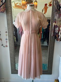 This 70's vintage Gunne Sax dress is adorable! Features light pink fabric, lace Peter Pan collar, lace trimmed hem and sleeves, button front closure, and ties at the back. Best fits Small. Approximate measurements: Pit to pit: 16.5" Waist: 25" Length: 47" Pink 70s Dress, Modest Church Outfits, Crepe Suzette, Vintage Gunne Sax Dress, Dress With Peter Pan Collar, Banana Candy, Light Pink Fabric, Sax Dress, 70s Inspired Fashion