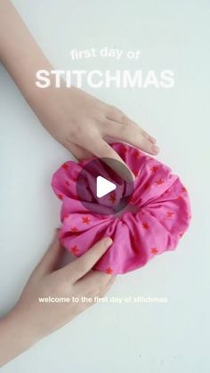 a person holding a pink flower with the words first day of stitchmas on it