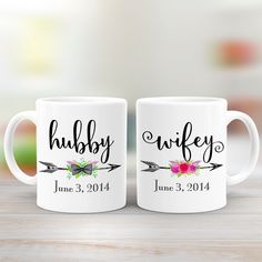 two white coffee mugs with the words hubby and wife printed on each one