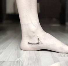 a person's foot with a small boat on it