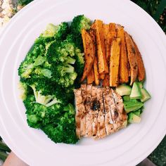 a white plate topped with meat and veggies