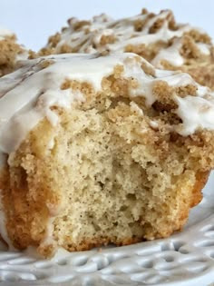 a muffin with white icing sitting on a plate