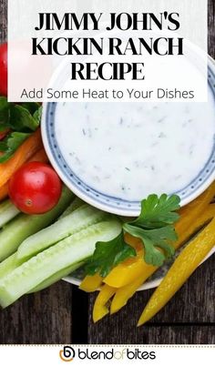 a white bowl filled with vegetables and dip next to some other ingredients on a wooden table