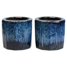 two blue vases sitting next to each other