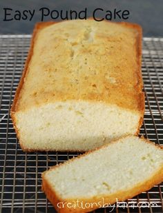 a loaf of bread sitting on top of a cooling rack next to a slice of cake