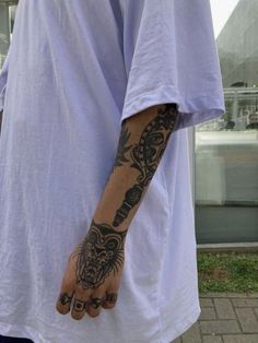 a man with tattoos on his arm and hand