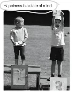 two young children standing on top of blocks with the caption happiness is a state of mind