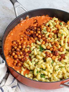 a pan filled with pasta and chickpeas in tomato sauce