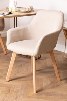 a white chair sitting in front of a wooden table