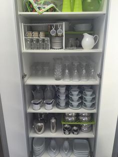 the shelves are filled with dishes, cups and other kitchen wares for storage or display