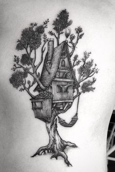 a tree house tattoo on the back of a man