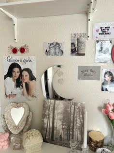 a white desk topped with pictures and other items