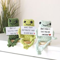 three little crocheted toys sitting on top of a shelf